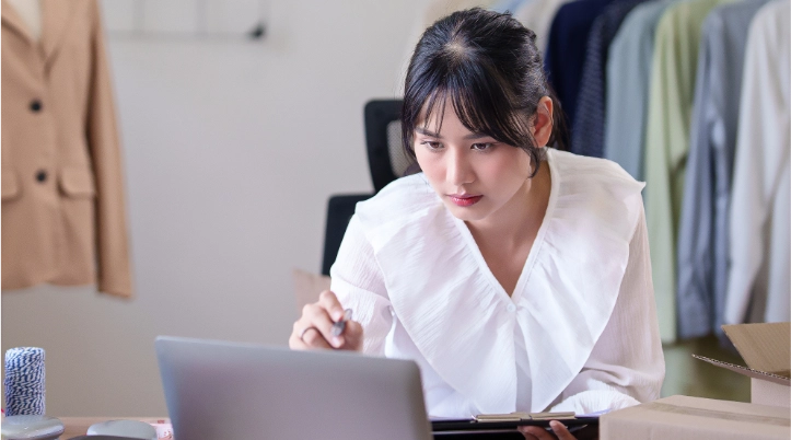Man in business clothing smiling at phone